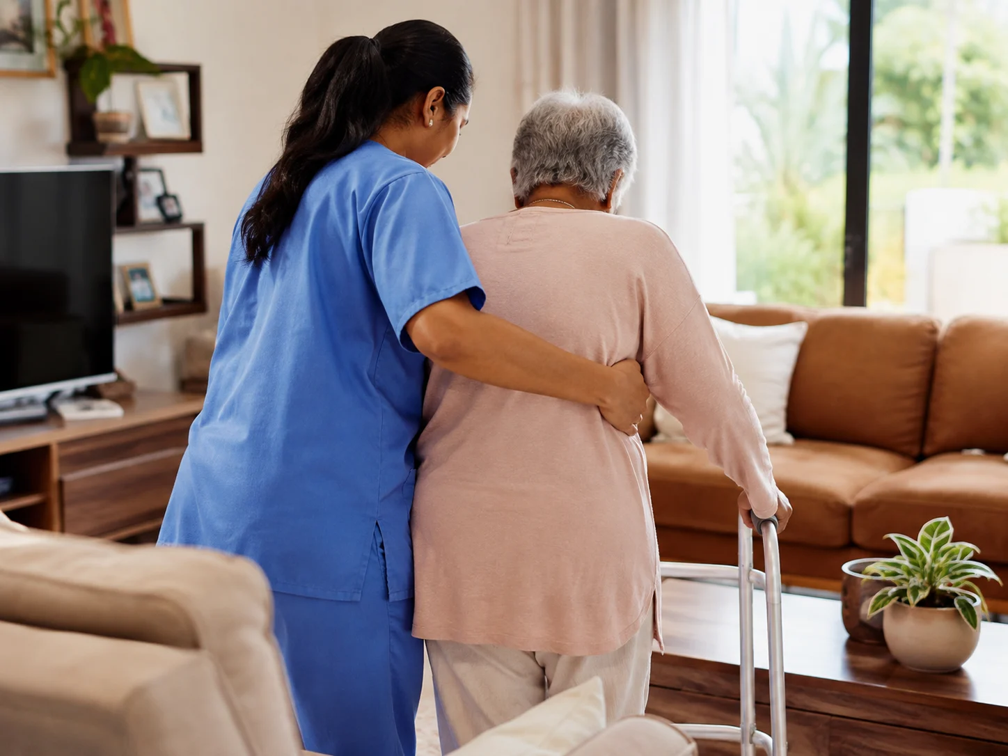 A home care nurse assisting an older patient